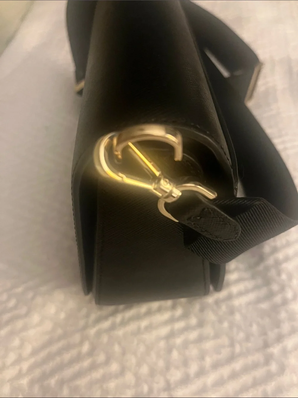 Kate Spade black crossbody saddlebag with gold logo